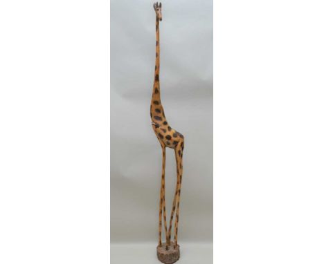 A MID 20TH CENTURY HAND CARVED FREE-STANDING GIRAFFE, fashioned from a single trunk, 188cm high (responds to the name of "Gil