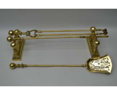 A SET OF THREE GEORGIAN DESIGN BRASS FIRE TOOLS, comprising; tongs, shovel and poker, together with a pair of brass fire tool