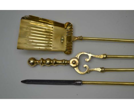 A SET OF THREE GEORGIAN DESIGN BRASS FIRE TOOLS, comprising tongs, shovel and poker. Condition report: lengths / poker 65cm /