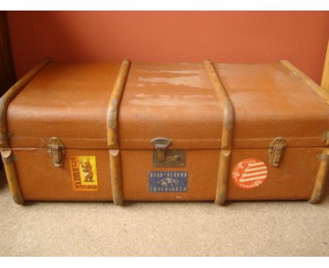An early 20th Century wooden bound canvas cabin trunk with labels. 