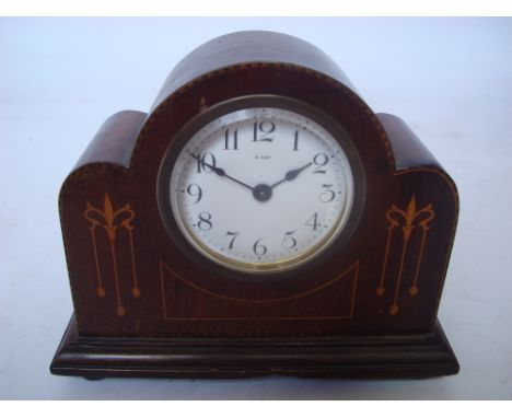 An Edwardian marquetry inlaid mahogany mantle clock, the white enamel dial with Arabic numerals and 8 day movement. 