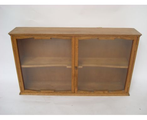 An Arts and Crafts light oak glazed hanging cabinet.
102 x 20 x 58cm high. 