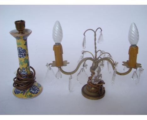 A Chinese famille jeune candlestick decorated with blue and white Chinese vases and two light gilt brass candleabra with glas