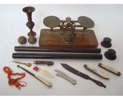 A set of gilt brass letter scales with weights on oak plinth base, two hardwood rulers, a silver bladed mother of pearl foldi