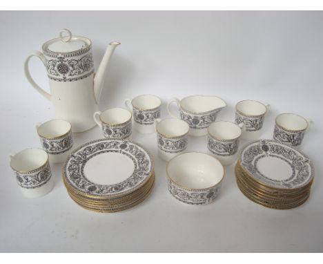 A Royal Worcester 'Padua' pattern eight setting coffee service comprising coffee pot and cover, milk jug, sugar bowl, eight c