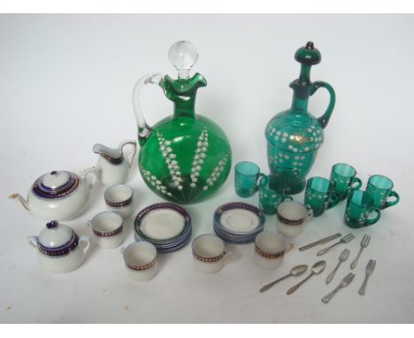 A late 19th Century Continental green glass liqueur set and claret jug and stopper decorated in white enamel with lily of the