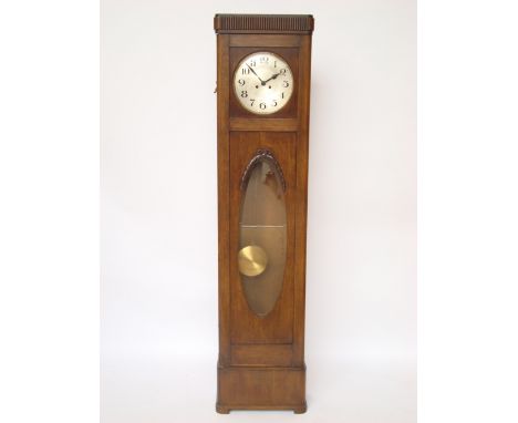 An early 20th Century oak longcase clock, the circular silvered dial with Arabic numerals and minute track, the eight day str