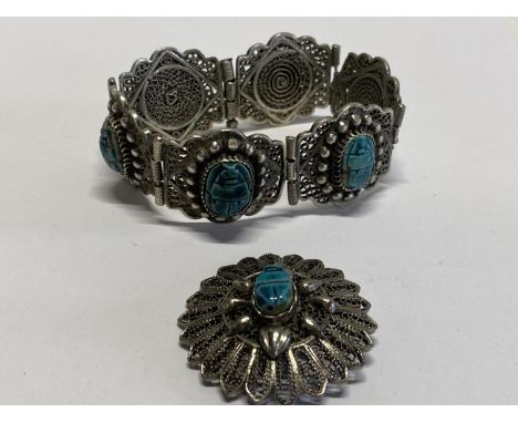 A vintage white metal bangle and brooch