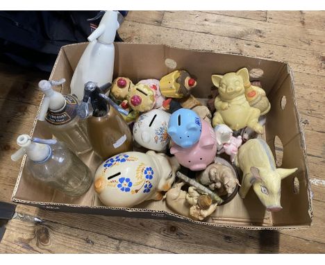 A job lot of assorted ceramic money boxes including soda syphons, shipping unavailable