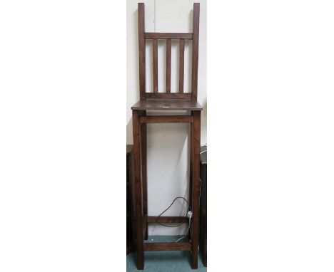 A 20th century beech Glasgow School of Art style plant stand in the form of a tall rail back stool, 193cm high x 45cm wide x 