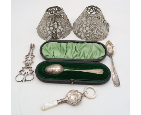 A pair of American silver lamp shades, by Gorham, a silver and mother of pearl babys rattle, by William Adams, Birmingham, a 