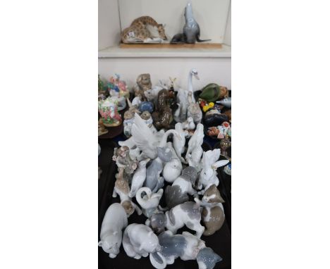 A collection of Lladro and Nao figures of animals and birds, together with a Bing and Grondal Polar Bear, Heredities otter gr