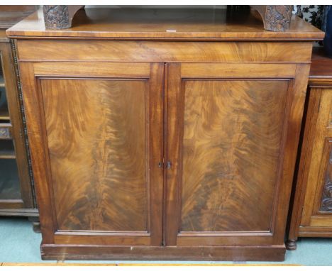 A Victorian mahogany linen press with pair of panel doors concealing drawers on plinth base, 118cm high x 128cm wide x 59cm d