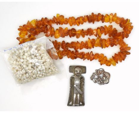 A silver David Andersen Viking themed pendant brooch, a further white metal art nouveau style brooch, a string of amber beads
