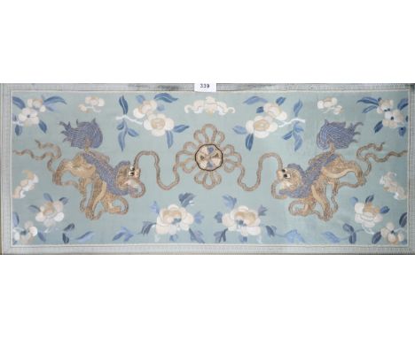 A Chinese silk panel, depicting a pair of Kylin on a blue ground surrounded by bats and flowers, 75 x 33cm, a sleeve panel de