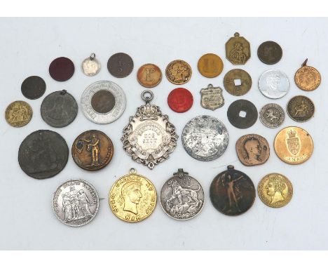 A lot comprising a National Dog Show 1899 winners medal, a Victorian rotating game counter, various tokens and war medals Con