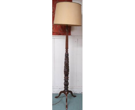 A 20th century standard lamp carved with spiralling acanthus leaves on tripod base, 189cm high Condition Report:Available upo
