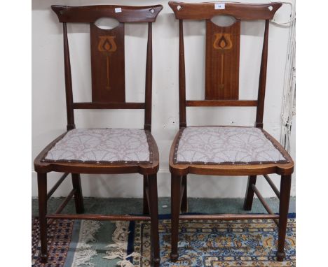 A pair of late Victorian mahogany framed Art Nouveau chairs with pierced samplewood inlaid back rests over upholstered seats 