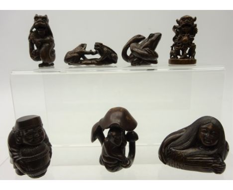 Six Japanese carved hardwood Katabori Netsuke; snake wrapped around a toad, monkey and mushrooms, dragons, figures and a carv