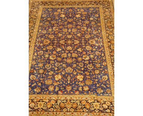 Large Persian Kashan carpet, blue ground field with interlacing floral design, repeated within the border, 450cm x 320cm