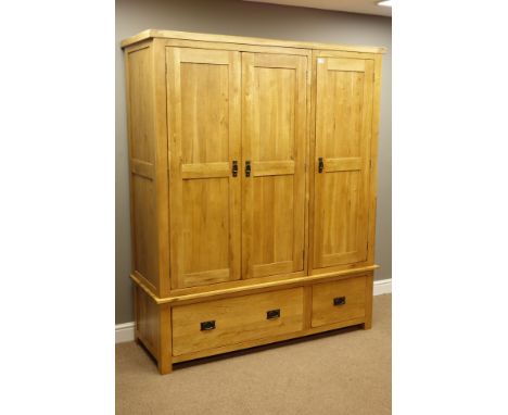 Light oak triple wardrobe, three panelled doors enclosing hanging space, two drawers to base, W161cm, H194cm, D58cm