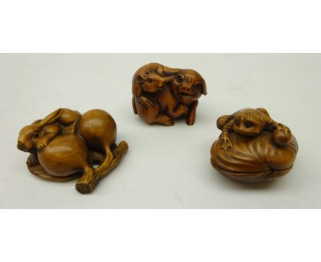Three Japanese carved stained boxwood Katabori Netsuke; pig and mouse group, mythical creature on shell and rabbit with fruit