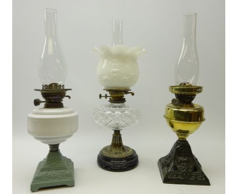 Victorian brass oil lamp with cut glass well on black ceramic base, and milk glass shade, H29cm and two other oil lamps (3)