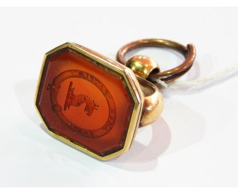 Large 19th century gold-coloured metal seal set with shaped rectangular carved cornelian, engraved with oval crest, having ar