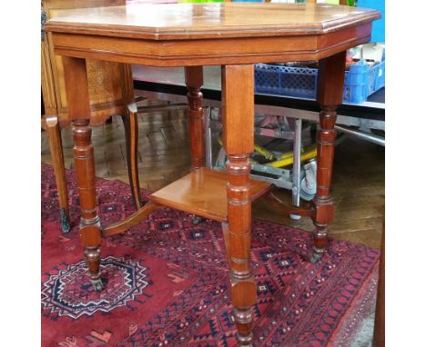 Late 19th century walnut octagonal top table with ring turned legs united by cross-stretcher, on castors, width 73cm 