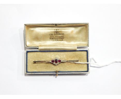 9ct white gold, ruby and diamond bar brooch set three oval rubies surrounded by diamonds in central flowerhead, diamonds to t