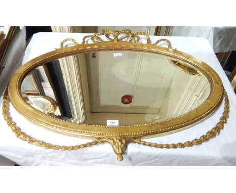 Oval gilded mirror with scroll top and floral bottom decoration 