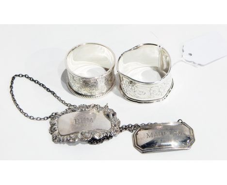 20th century silver napkin ring with floral engraving and bead border with another, two silver bottle labels, Madeira and Rum