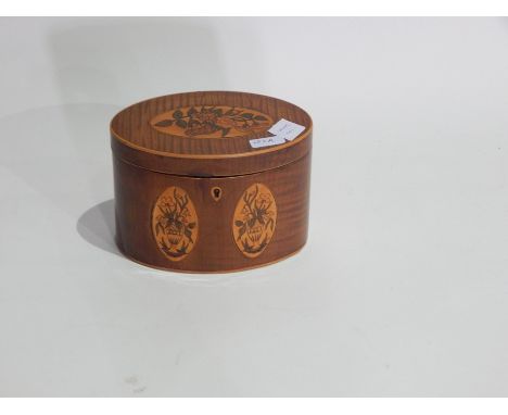 Regency inlaid mahogany oval tea caddy with floral cartouches and having single fitted compartment to interior, 15 cms wide