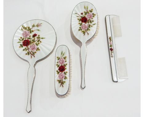 Silver and engine turned enamel dressing table set, rose decorated, comprising hand mirror, hand brush, clothes brush and com