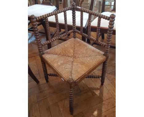 Victorian bobbin turned corner chair with rush seat, legs united by cross stretcher 