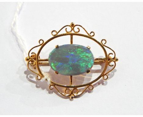 9ct gold, opal and doublet brooch set oval stone in pierced oval and scroll mount 