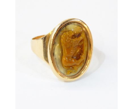 19th century carved hardstone and gold-coloured metal cameo ring, the oval beige and cream hardstone cameo carved with lion 