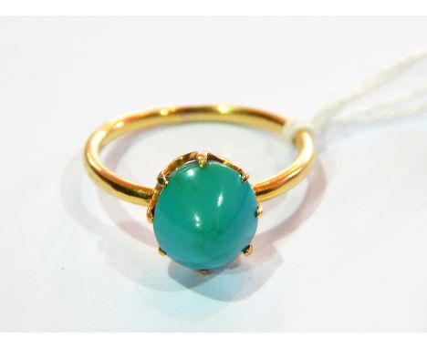 Gold-coloured metal and turquoise ring set pointed oval turquoise stone, claw set 