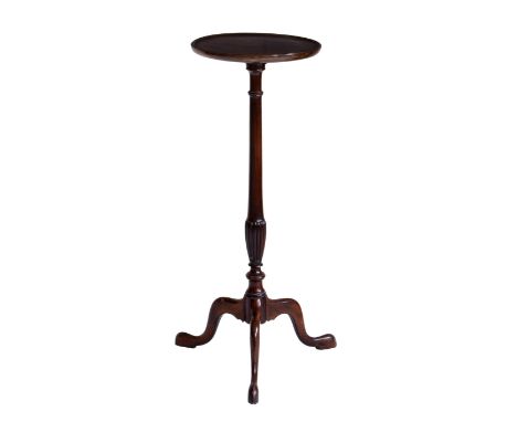 A George III style mahogany lamp table, 1920s-30s, the dished, circular top on a turned and reeded column to three swept legs