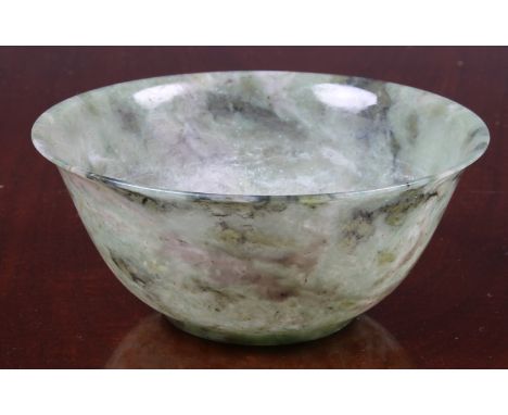 A carved green jade style hardstone bowl, 20th century, 4 7/8 (12.4cm.) diameter, 2¼in. (5.7cm.) high, in a fitted silk cover