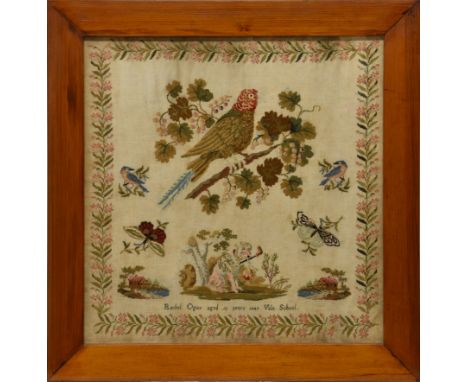A framed Victorian needlework sampler, with a floral border and dog, bird and butterfly main panel with a mirrored picture of