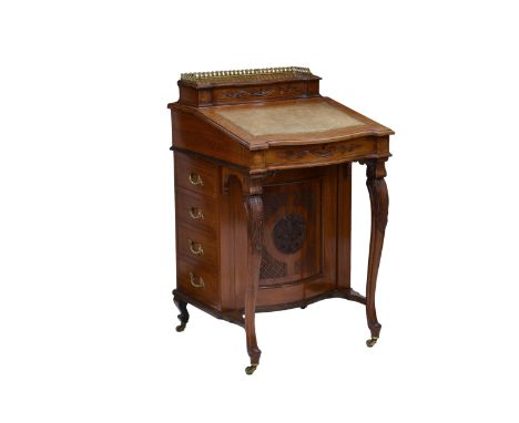 A Victorian carved walnut Davenport, the ¾ galleried hinged top opening to a fitted stationary compartment over the serpentin