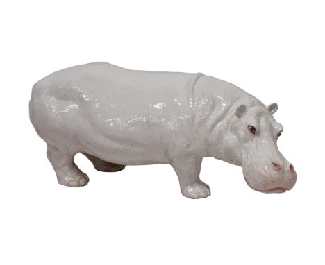 A large white glazed Italian terracotta hippopotamus, having realistic features, modelled in a standing position, the core ho