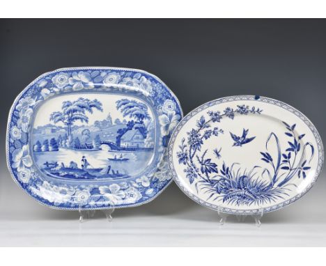An early 19th century large blue and white pottery meat platter, printed with 'Wild Rose' pattern, 22in. (55.8cm.) wide, toge