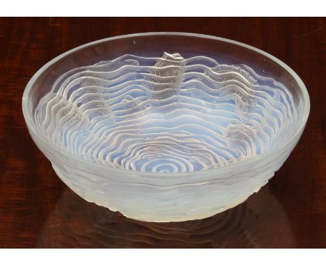 A Lalique opaline glass 'Dauphins' bowl, with multiple species of impressed fish, swimming among spiral waves to the outer su