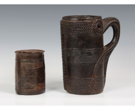 A Nepal (Upper Mustang) carved wood milk jug, probably early 20th century, the stylised handle with rope carved decoration, t