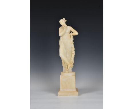 An alabaster figure of a classical maiden, carved in standing position, draped in cloak, holding a floral garland, raised on 