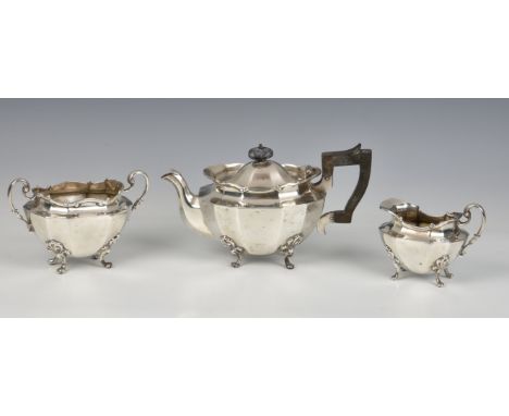 A Scottish three piece silver bachelor's tea service, Hamilton &amp; Inches, Edinburgh, 1906, of panelled oval form with foli