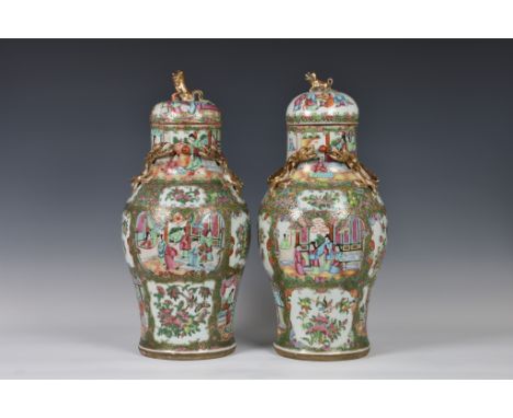 A closely matched pair of 19th century Chinese Canton famille rose covered vases, the vases of baluster form with elongated n