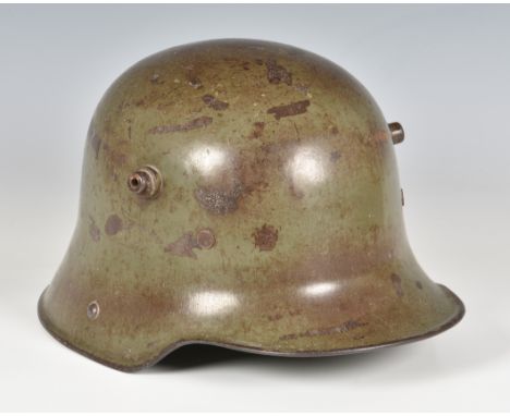 An original WWI First World War Imperial German Army steel combat helmet, painted green, with twin side lugs, no inners. 